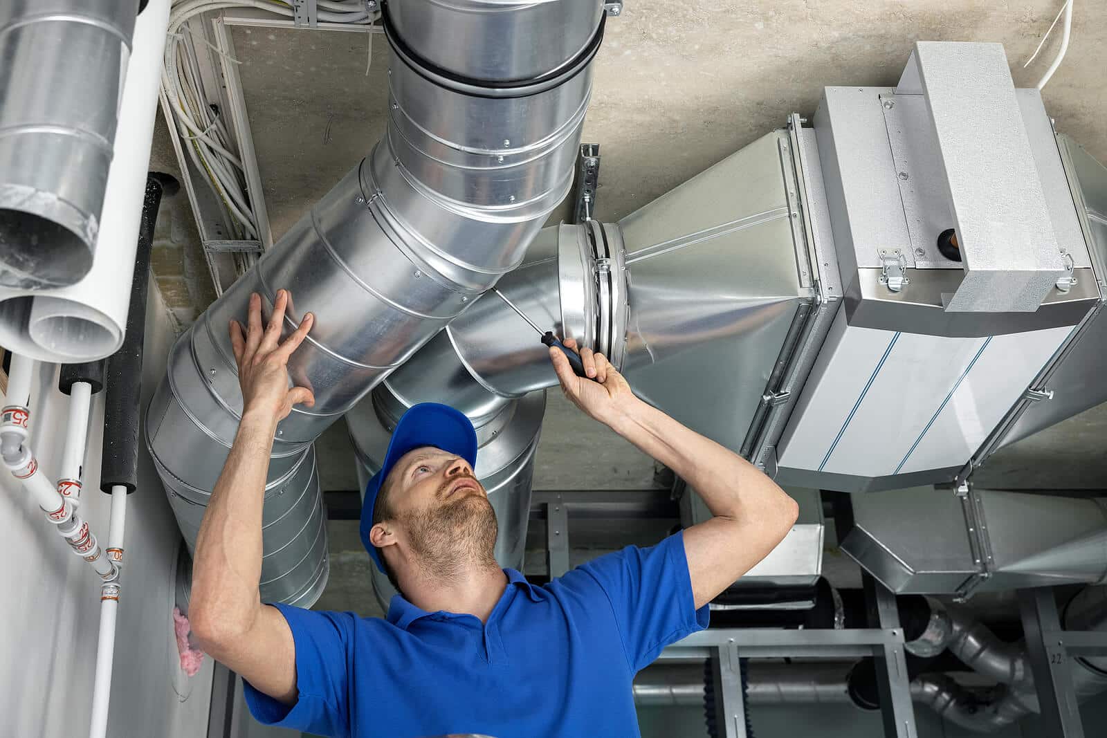 HVAC technician inspecting and repairing air ducts in North Highlands