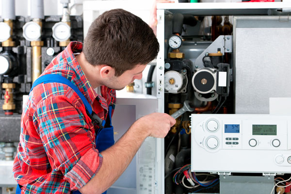 Heating technician repairing boiler controls in North Highlands