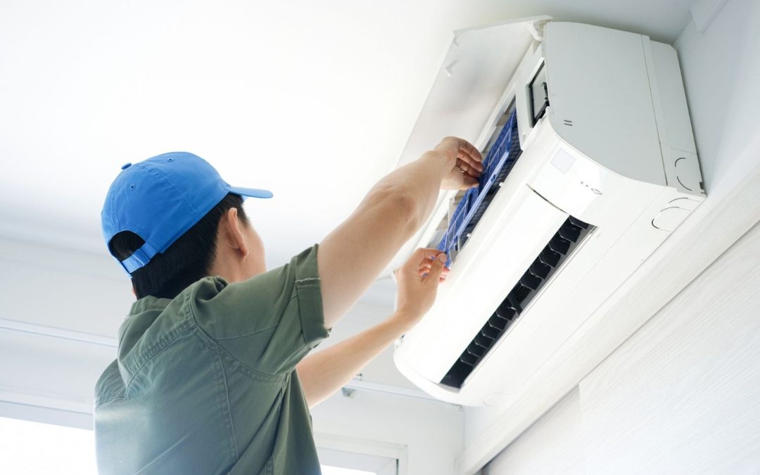 HVAC technician servicing a ductless mini split in North Highlands