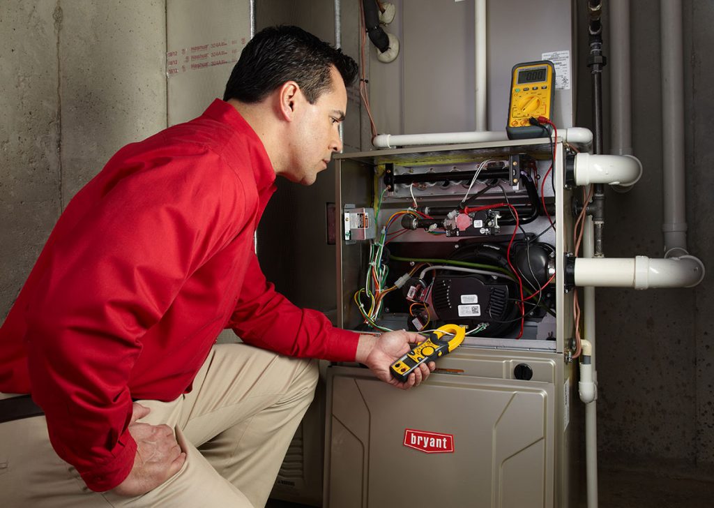 Heating technician diagnosing a furnace repair in North Highlands