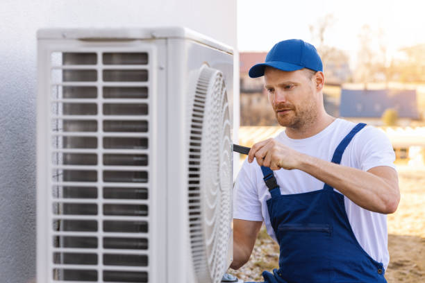 HVAC technician servicing an outdoor air conditioner in North Highlands