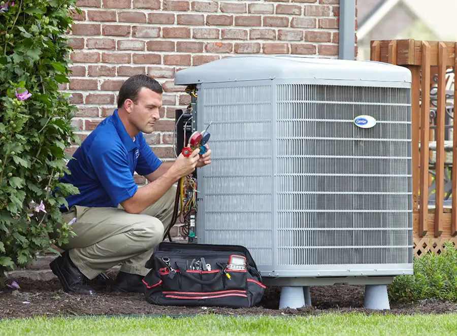HVAC technician inspecting an outdoor AC unit in North Highlands