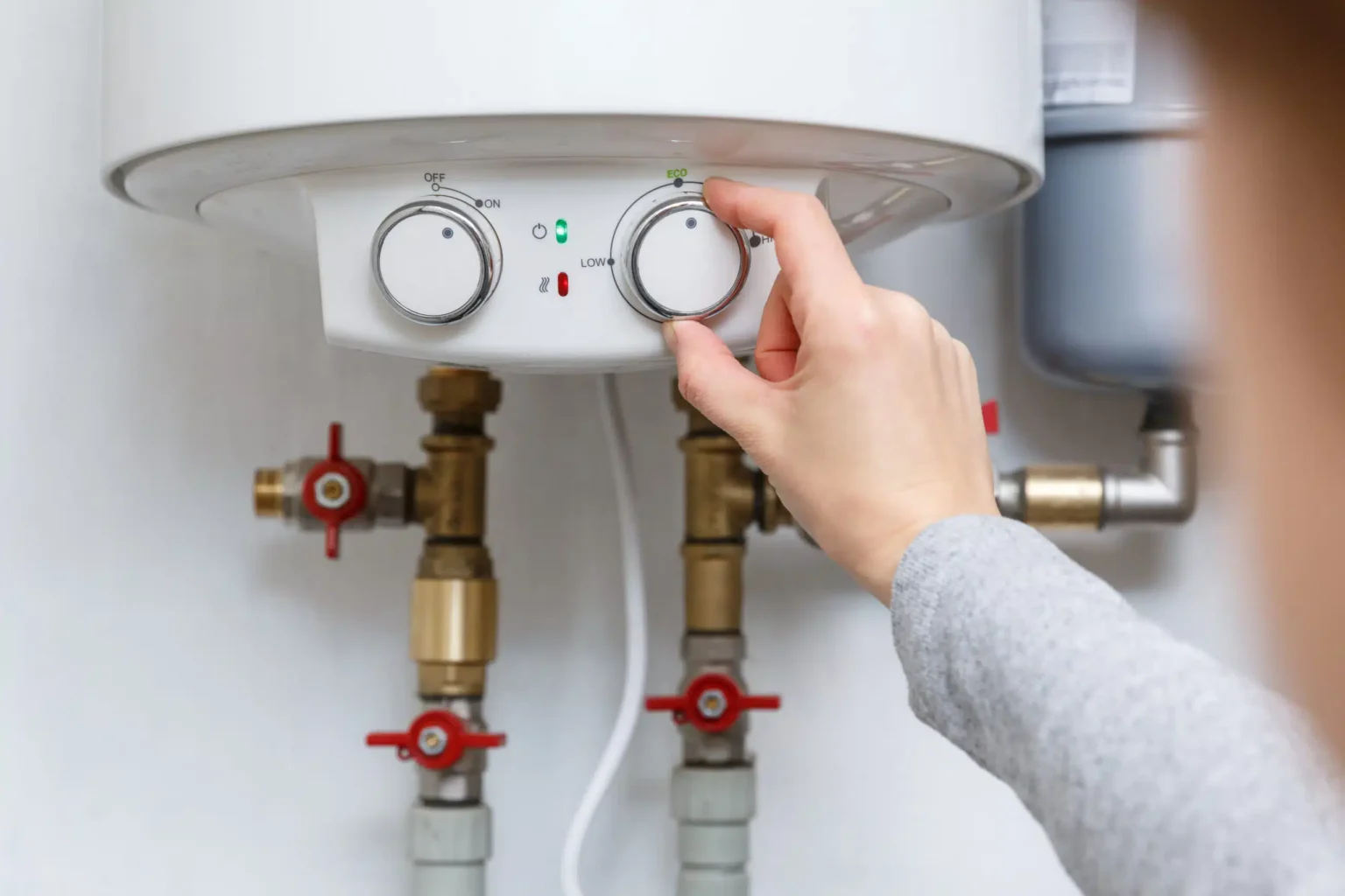 Technician adjusting a water heater in North Highlands