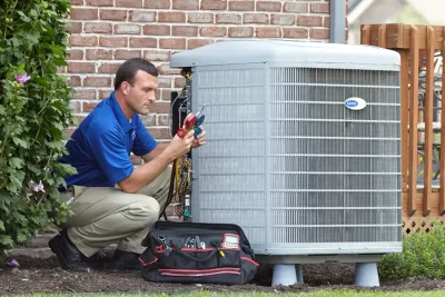 Outdoor AC Unit Inspection North Highlands HVAC technician inspecting an outdoor AC unit in North Highlands